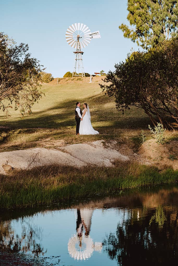 wedding couple at the Old Station in front of a windmill